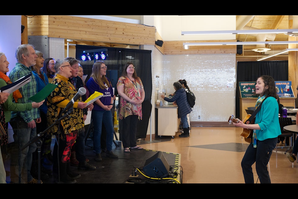 Erica Dee Ma conducts and plays guitar accompaniment for the Yukon University Choir kicking off the True Colours Talent Show on Feb. 27. (Jim Elliot/Yukon News)