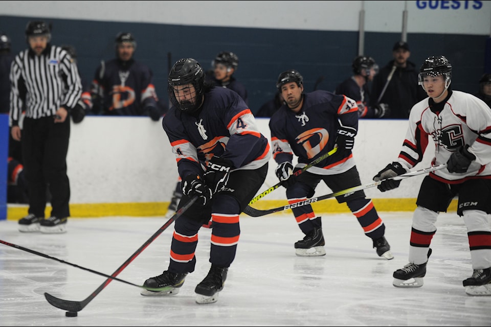 Delta Ducks scramble for the puck in a defensive effort to move it to the other side of the rink. (Jake Howarth/Yukon News)