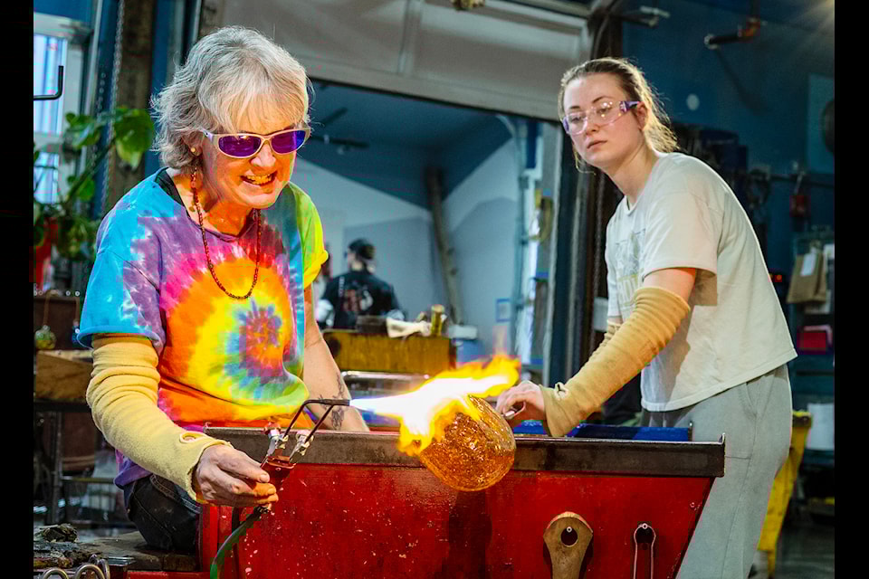 Luann Baker-Johnson, left, working on a glass beetle genitalia at her business Lumel Studios. (Mike Thomas/Yukon Arts Centre)