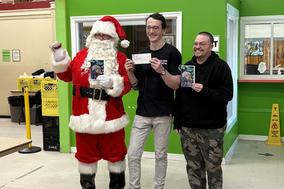 The Food Bank Society of the Yukon benefitted from a bit of Christmas in the middle of May as Whitehorse's Garbage Truck Santa dropped off the proceeds from selling Christmas cards bearing his image on May 14, 2025. (Submitted)