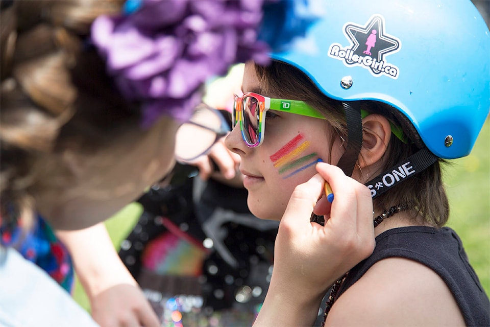 Story Blottner, 11, gets a Pride flag painted on her face during parade preparations in Whitehorse on June 8, 2019. (Crystal Schick/Yukon News)