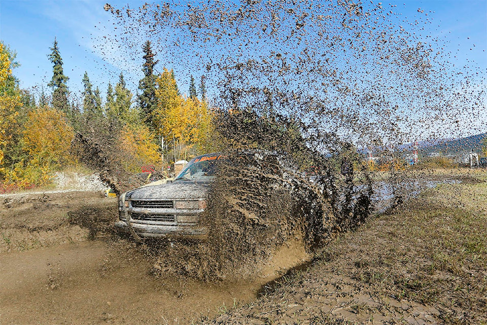 Crystal Schick/Yukon News Ian Nichols makes a big splash with his truck, Black Betty, during the 2019 Whitehorse mud bogs on Sept. 7, 2019.