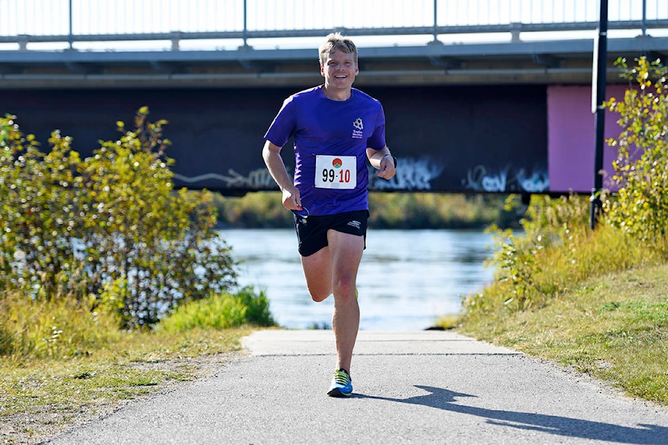 Harry Borlase from team Takhini Houdini Drinking a Martini in a Bikini runs the final stretch into the finish of the Klondike Trail of ‘98 International Road Relay at Rotary Park in Whitehorse on Sept. 7, 2019. (John Hopkins-Hill/Yukon News)