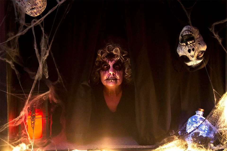 Lil Huston pops her head out from behind a curtain at The Guild Hall’s box office in Whitehorse on Oct. 26. Huston was the first fright at the start of The Guild’s annual haunted house. (Crystal Schick/Yukon News)