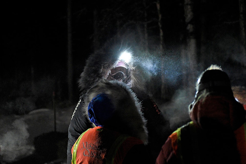 Allen Moore speaks to Yukon Quest officials after arriving at the Two Rivers checkpoint on Feb. 1. (John Hopkins-Hill/Yukon News)