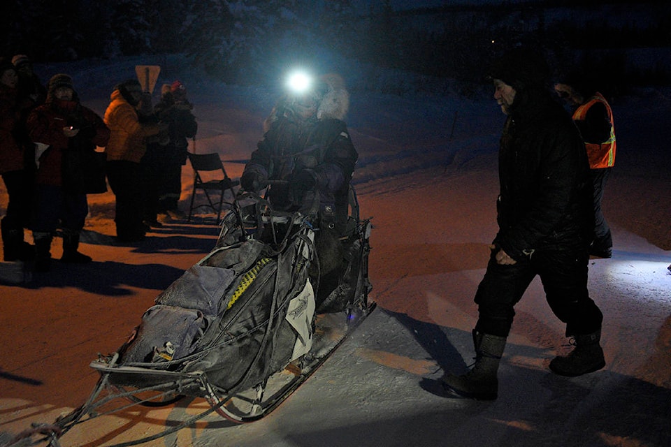 Michelle Phillips arrives at the Pelly Crossing checkpoint on Feb. 9 during the 2020 Yukon Quest. Phillips was the first musher to reach the checkpoint, officially checking in at 8:11 a.m. with 12 dogs on the line. (John Hopkins-Hill/Yukon News)