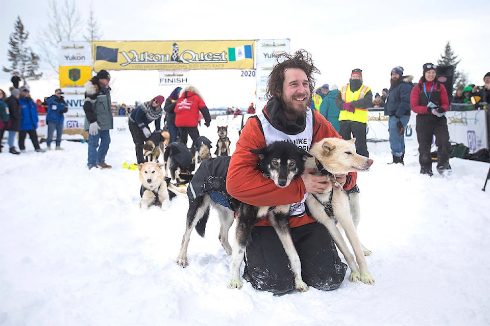 Brent Sass poses with his lead dogs after crossing the finish line in Whitehorse on Feb. 11 to win his third Yukon Quest. (Crystal Schick/Yukon News file)