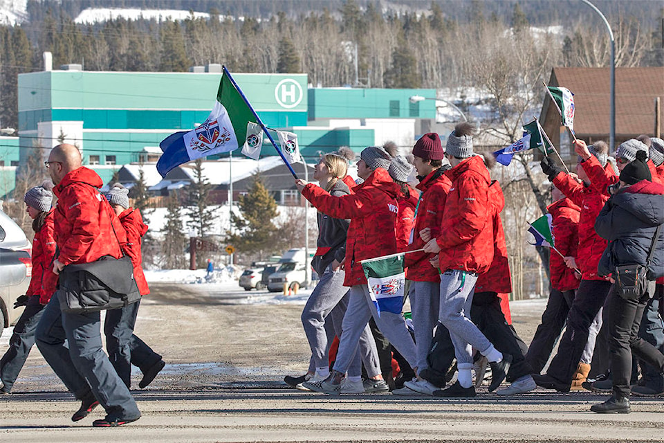 Hundreds of Arctic Winter Games athletes, volunteers and supporters march in a parade up Fourth Avenue to Main Street in Whitehorse on March 15, 2020. (Crystal Schick/Yukon News)