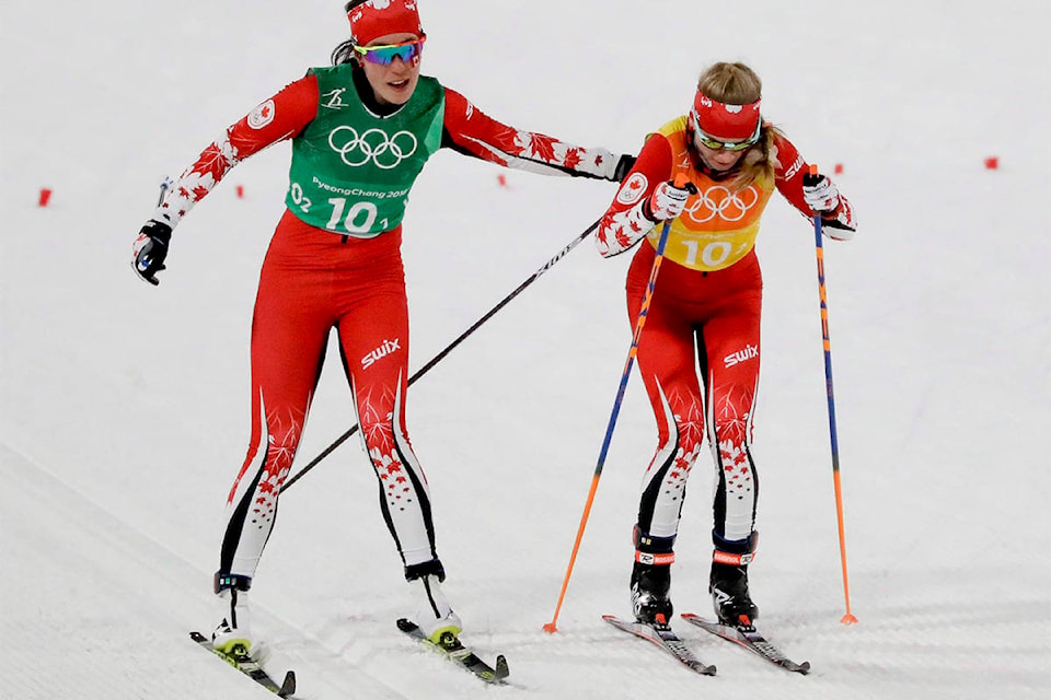 Emily Nishikawa, of Canada, left, hands off to Cendrine Browne during the women’s four by five-kilometre relay cross-country skiing competition at the 2018 Winter Olympics in Pyeongchang, South Korea, on Feb. 17, 2018. (Kirsty Wigglesworth/AP file)