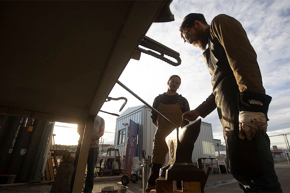 Blacksmithing instructor Jonathon Priscoll, right, explains how to work on the anvil during a blacksmithing workshop in Whitehorse on Sep. 7, 2020. (Crystal Schick/Yukon News)