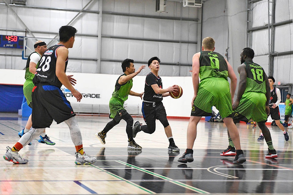 Josh Rumbaoa draws a crowd during game three of the Filipino Canadian Basketball League of Yukon under 35 finals on Nov. 15 at the Canada Games Centre. Rumbaoa had 12 points in the win and was named the season MVP. (John Hopkins-Hill/Yukon News)