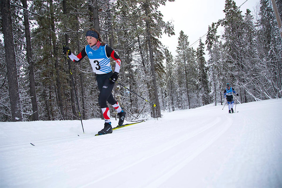 Abigail Jirousek, left, is tailed by Brian Horton while climbing a hill during the Cross Country Yukon January Classic in Whitehorse on Jan. 23. Jirousek finished second in the U16 girls category. (Crystal Schick/Yukon News)