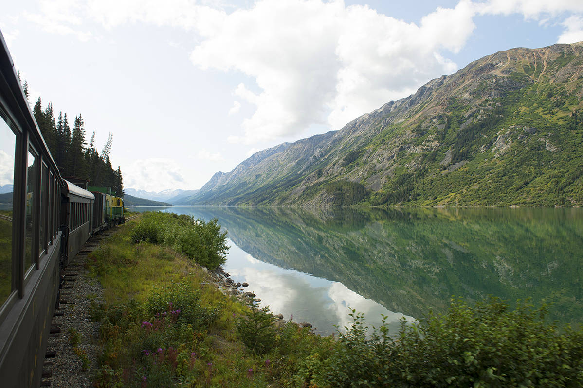 Enjoy stunning views while onboard the White Pass train, such as this remarkable scene captured while travelling along Lake Bennett. Photo courtesy Travel Yukon.