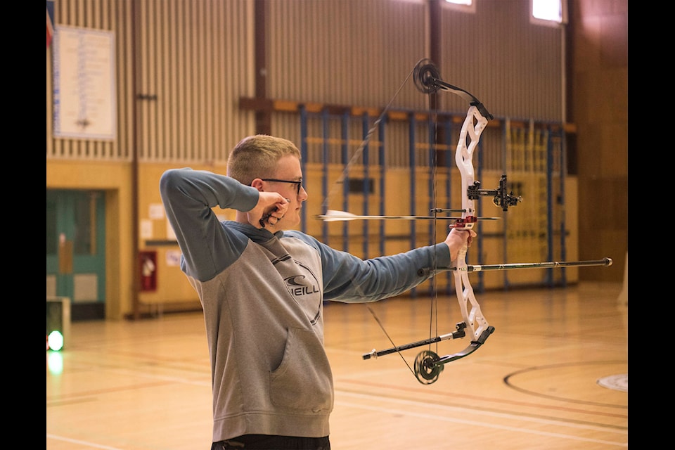 Samuel Bugg fires during a sanctioned shoot at Takhini Elementary in Whitehorse on April 28, 2021. Yukon archers are some of the only athletes able to shoot amidst the pandemic. (John Tonin/Yukon News)