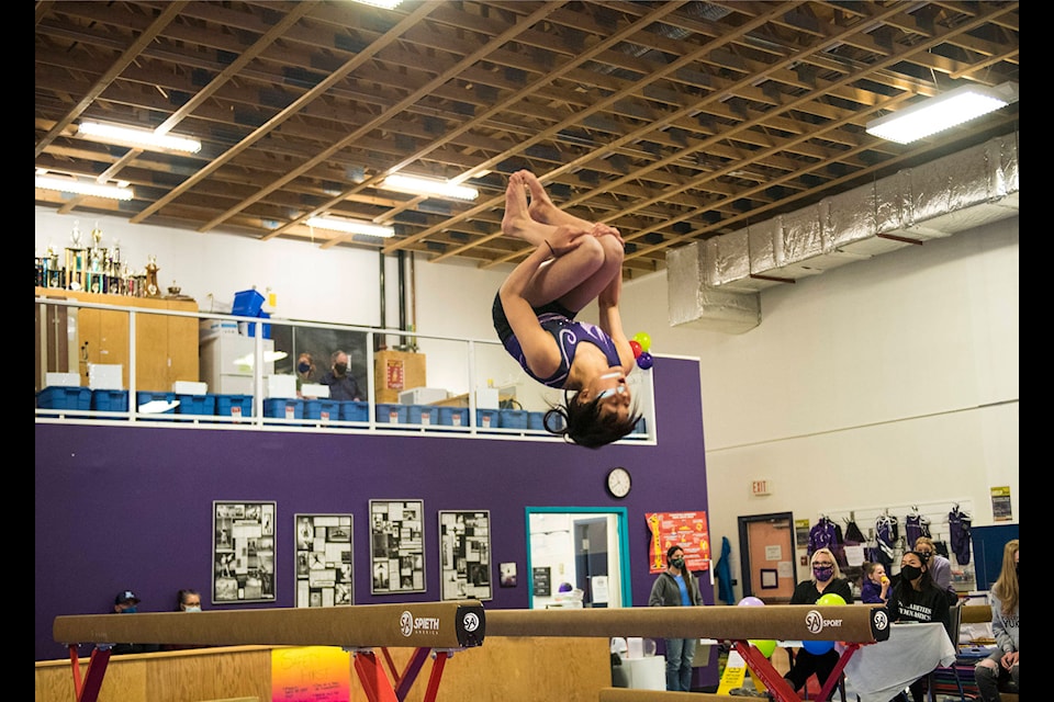 Chloe Tatsumi dismounts the balance beam to cap her routine during the Yukon Championships at the Polarettes Gymnastics Club on May 1. (John Tonin/Yukon News)