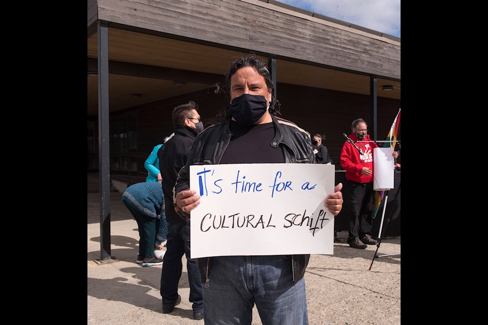 Ron Rousseau holds a sign saying ‘It’s time for a cultural shift’ during the Yukoners: Raise Your Voice Against Misogyny rally on May 11. (John Tonin/Yukon News)