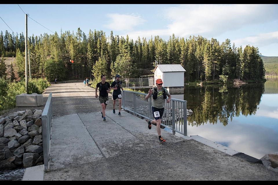 Three runners make their way past Jackson Lake headed toward Haeckel Hill. John Tonin/Yukon News