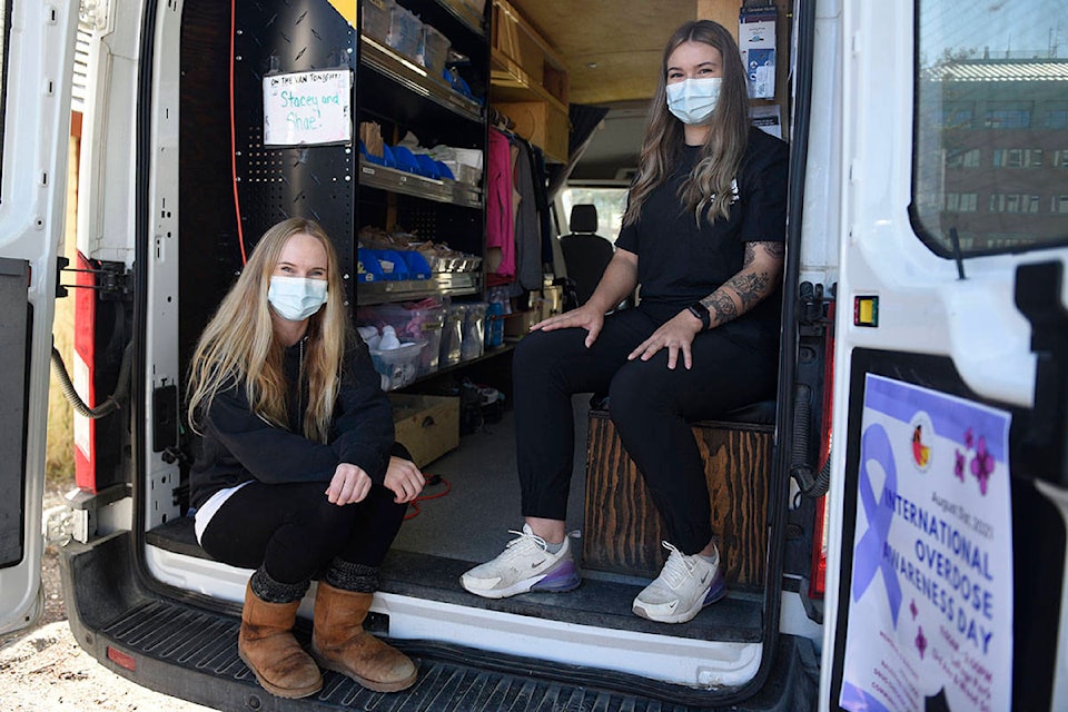 Outreach van staff Stacey Taylor (left) and Shae-Lynn Boyko (right) pose for a photo inside the Blood Ties Four Directions van. The program delivers harm reduction supplies around Whitehorse. (Haley Ritchie/Yukon News)