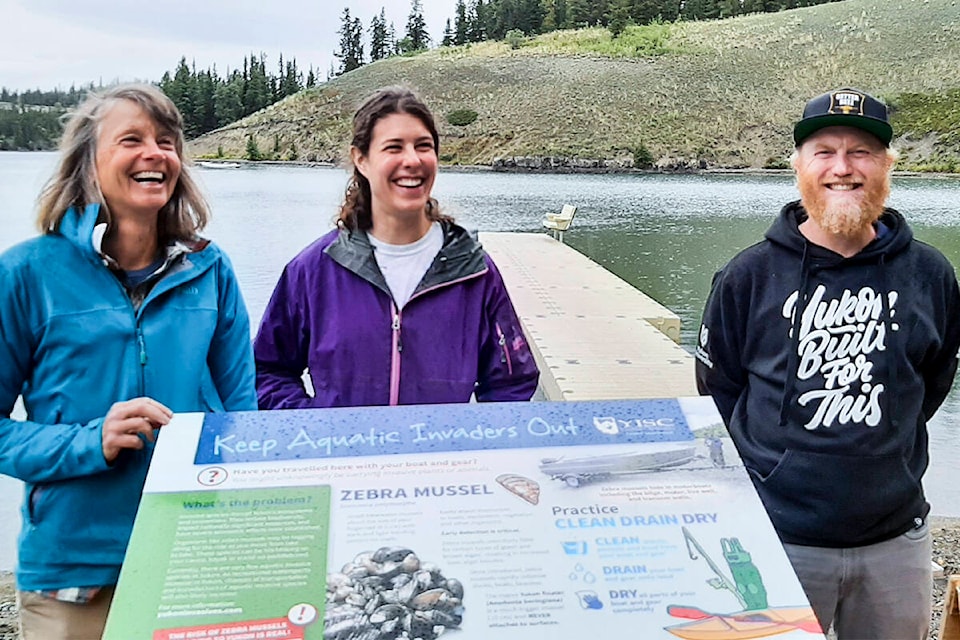 The Yukon Invasive Species Council unveiled its Clean, Drain, Dry sign on Sept. 3 at Schwatka Lake. Pictured are YISC executive director Andrea Altherr, Aven Knutson and YISC president Michel Duteau. (John Tonin/Yukon News)
