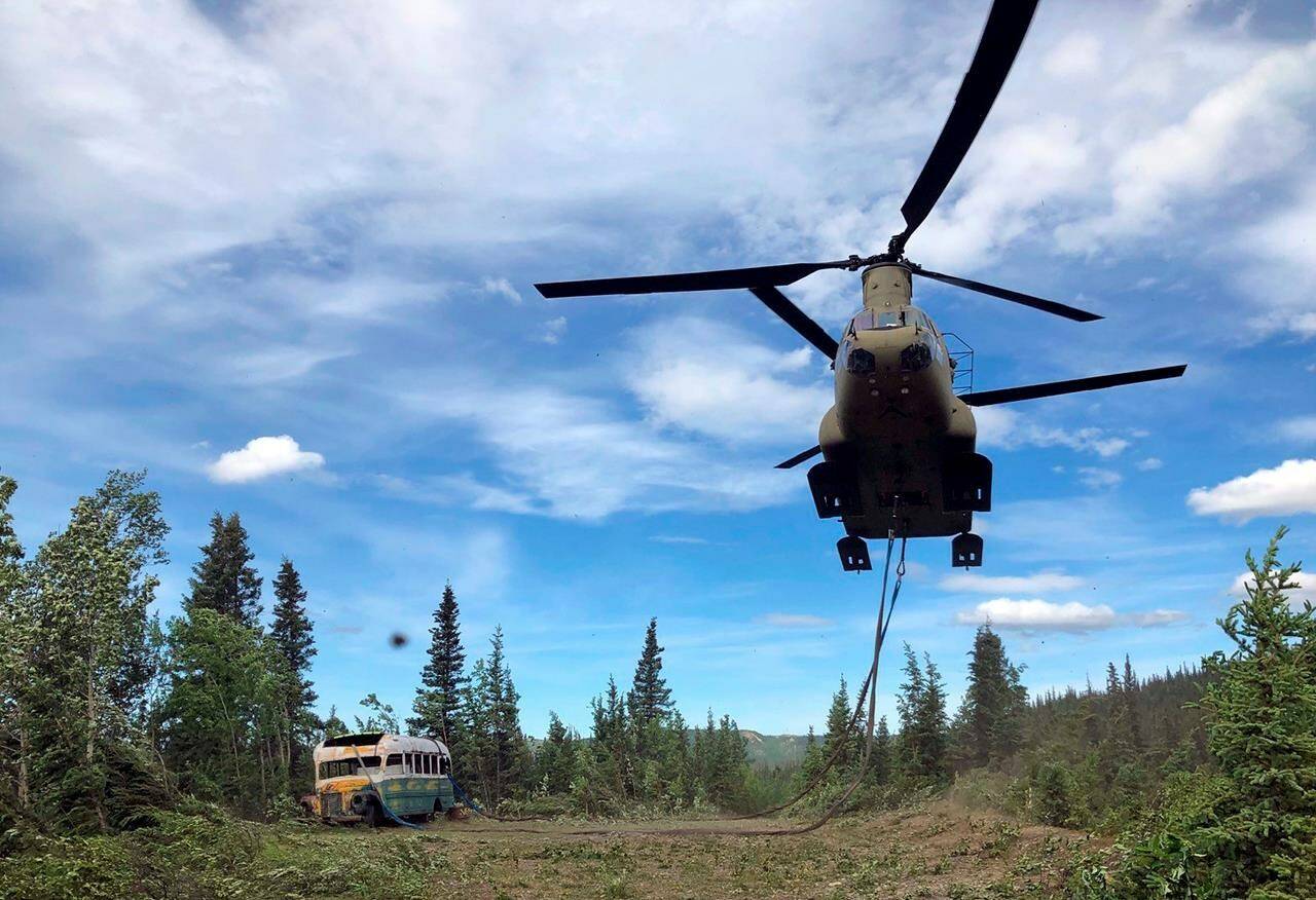 In this June 18, 2020, file photo released by the Alaska National Guard, soldiers use a CH-47 Chinook helicopter to removed an abandoned bus, popularized by the book and movie Into the Wild, out of its location in the Alaska backcountry as part of a training mission. (Sgt. Seth LaCount/Alaska National Guard via AP, File)