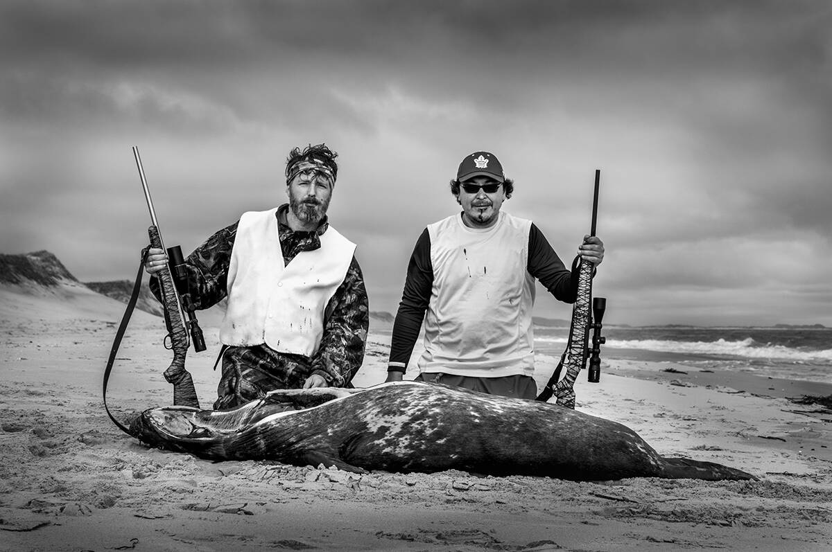 Yoanis Menge, left, and Ruben Komangapik posing with a grey seal following a hunting trip on Quebecs Magdalen Islands. They are the people behind a new project, called Reconseal Inuksiuti, which aims to celebrate both non-Indigenous and Indigenous seal hunting traditions. Photo courtesy of Yoanis Menge