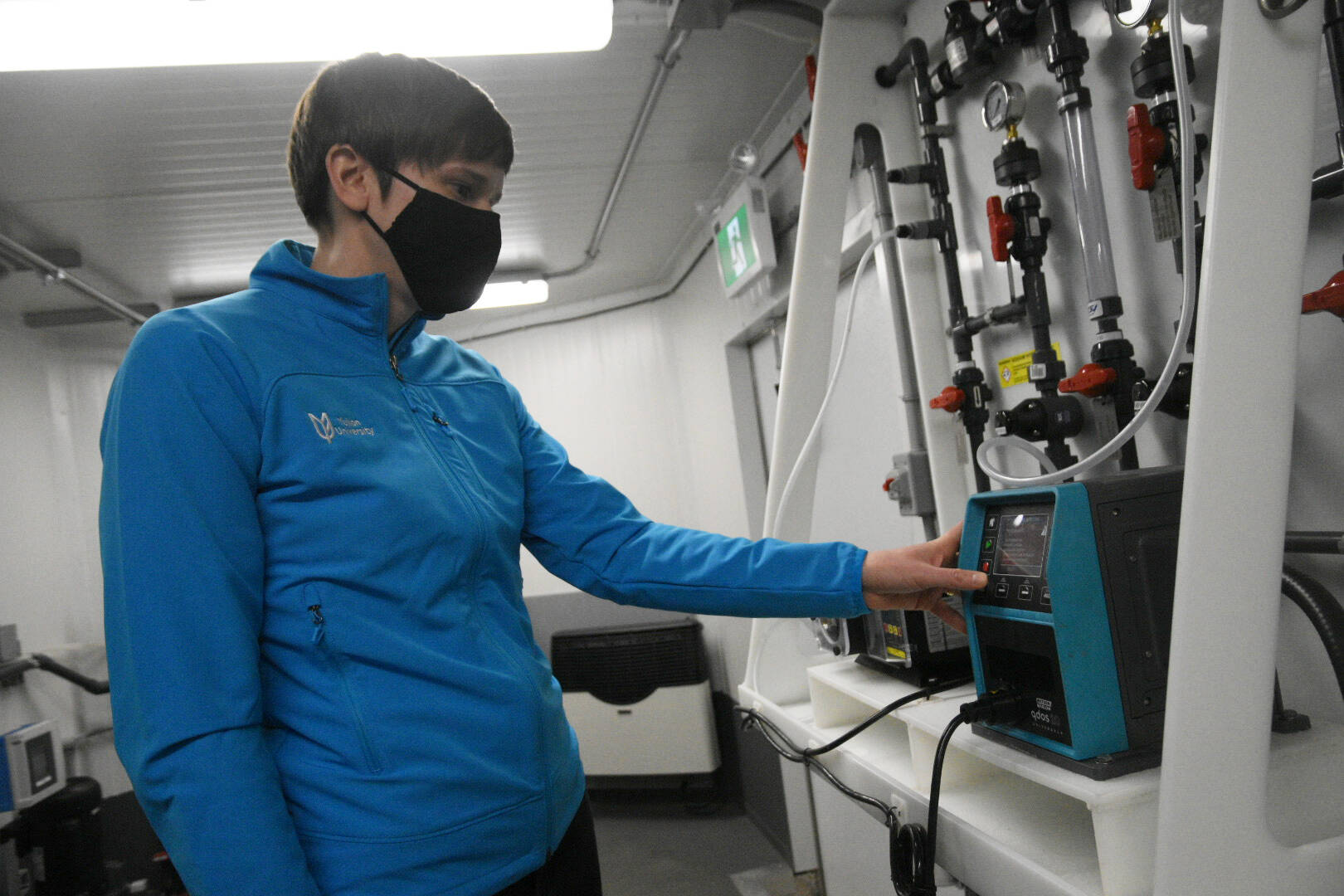 Alison Anderson adjusts the chlorine management system in the mobile water treatment lab that Yukon University will be using to train new small water system operators. (Jim Elliot/Yukon News)