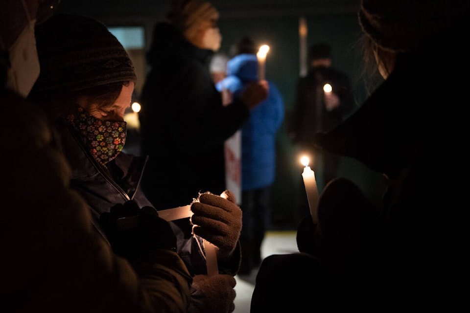 Yukoners lit candles and sang songs during an evening vigil on Feb. 11 outside the Whitehorse United Church. (Haley Ritchie/Yukon News)