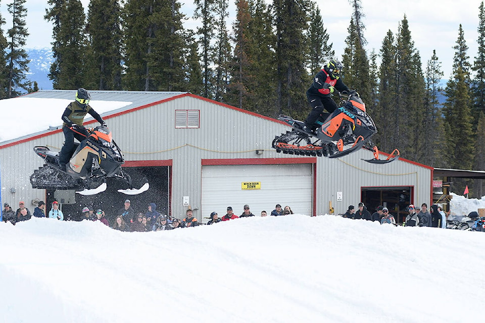 Snowmobilers and snow bikers raced head-to-head over jumps and sharp turns before heading straight up one of the ski runs at Mount Sima in Whitehorse on Apr. 23, 2022.