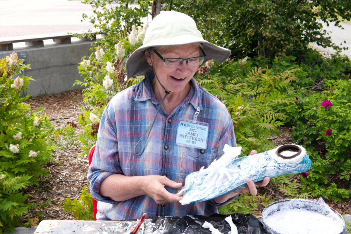 Janet Patterson works in mixed media near the wharf on July 25. (Gabrielle Plonka/Yukon News)