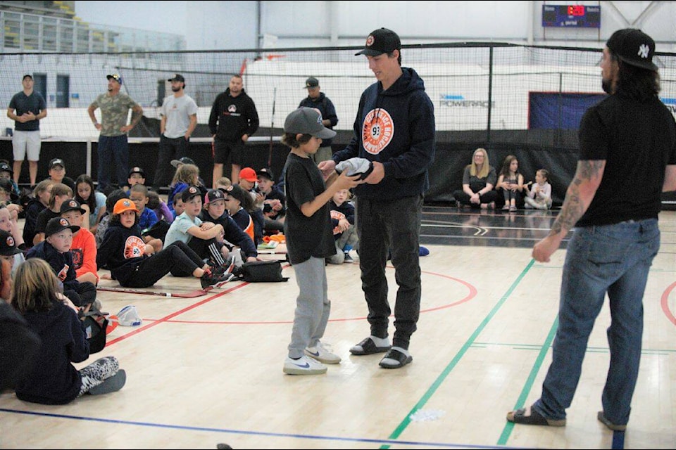 Players from the CYFN Centre Ice Hockey Camp receive Friday afternoon prizes. (Magan Carty/Yukon News)