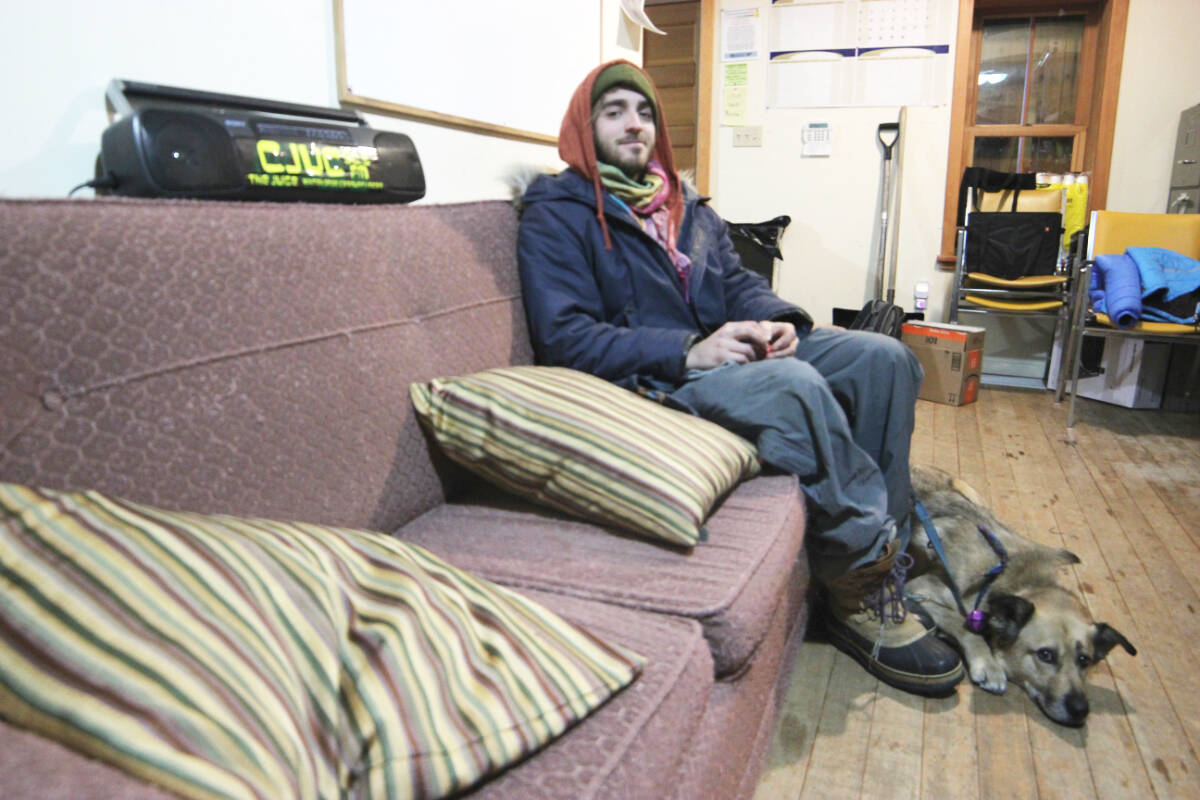 Matthew Toothill hangs out with dog Caesar at CJUC, where he hosts two shows. (Dylan MacNeil/Yukon News)