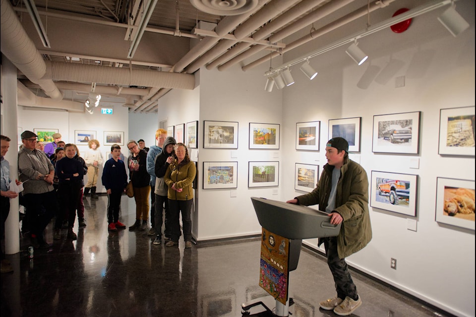 Eric Laniel, one of the participants in the Youth Roots: Photovoice project, discusses his photos on display at the exhibit’s April 14 opening. (Jim Elliot/Yukon News)
