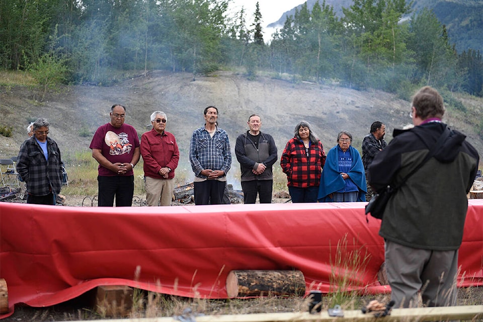 Chooutla School survivors, including Harold Gatensby, gathered in front of a healing canoe on the old school site in 2019. Gatensby invited survivors to share stories there on June 5, as ground-penetrating radar work began at the site. (Yukon News file)