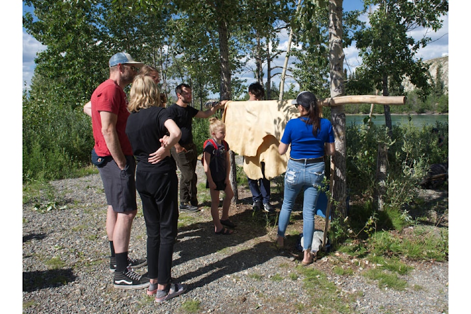 People gather around tanned hides at hide camp during the first day of the Adäka Cultural Festival. The festival runs from June 29 to July 5. (Amy Kenny/Yukon News)
