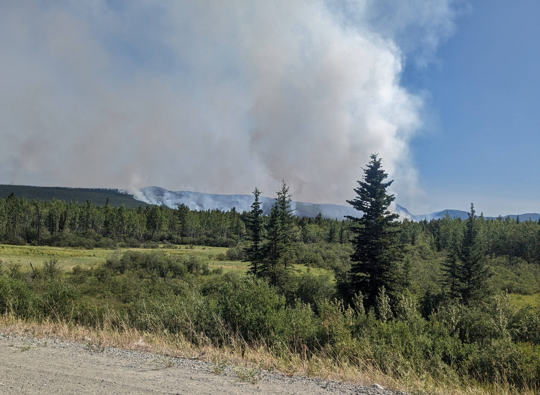 The fire in Ibex Valley seen from the Alaska Highway on June 9. (Matthew Bossons/Yukon News)
