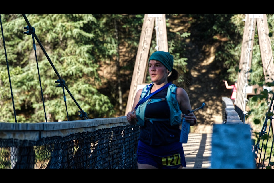 Annie-Claude Letendre crosses the Miles Canyon bridge into a patch of morning shade during the early kilometres of the Yukon River Trail Marathon. (Jim Elliot/Yukon News)