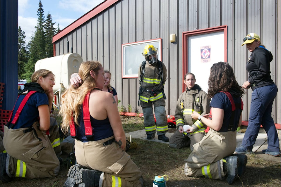 Recruits and instructors of Ember Fire Academy chat outside the Golden Horn Fire Department in Whitehorse on Aug. 18. (Matthew Bossons/Yukon News)