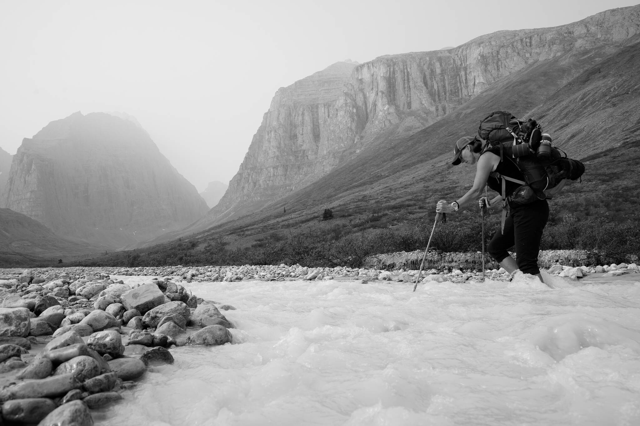 Terri Cairns crossing Milk Creek during an eight-day hike around Mount MacDonald. (Peter Mather/Yukon News)