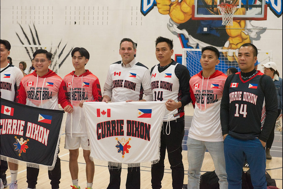 Yukon Party Leader Currie Dixon with players of Team Currie during the opening ceremony of the 17th edition of the Filipino Canadian Basketball tournament in Whitehorse. (Patrick Egwu/Yukon News)