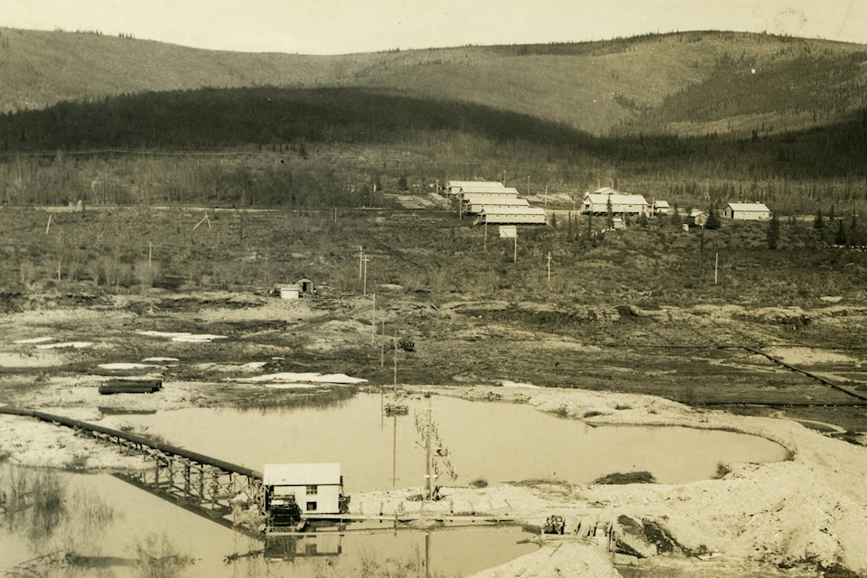 A typical dredge camp would consist of bunkhouses for the men and a mess hall where they could eat. Other support buildings would also be located at the camp, which would be located in close proximity to the stripping, thawing and dredging. Camps like these were situated close to all of the dredge operations on the Klondike River and Bonanza, Hunker, Dominion, Gold Run, Sulphur and Quartz Creeks. (Courtesy/Gates collection)