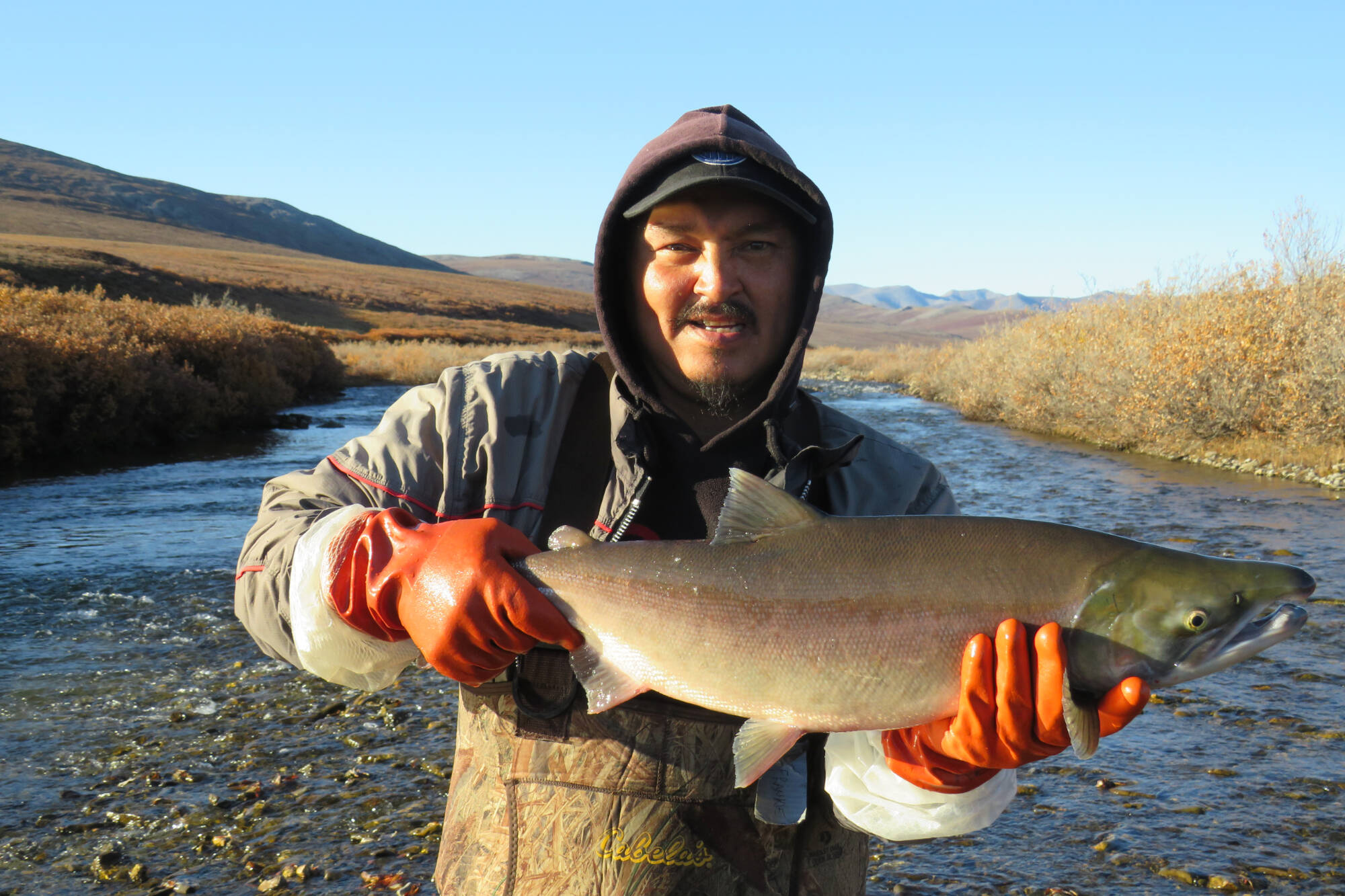 Frank Dillon holding a sockeye salmon in Fish Creek in 2017. (Submitted/Colin Gallagher)