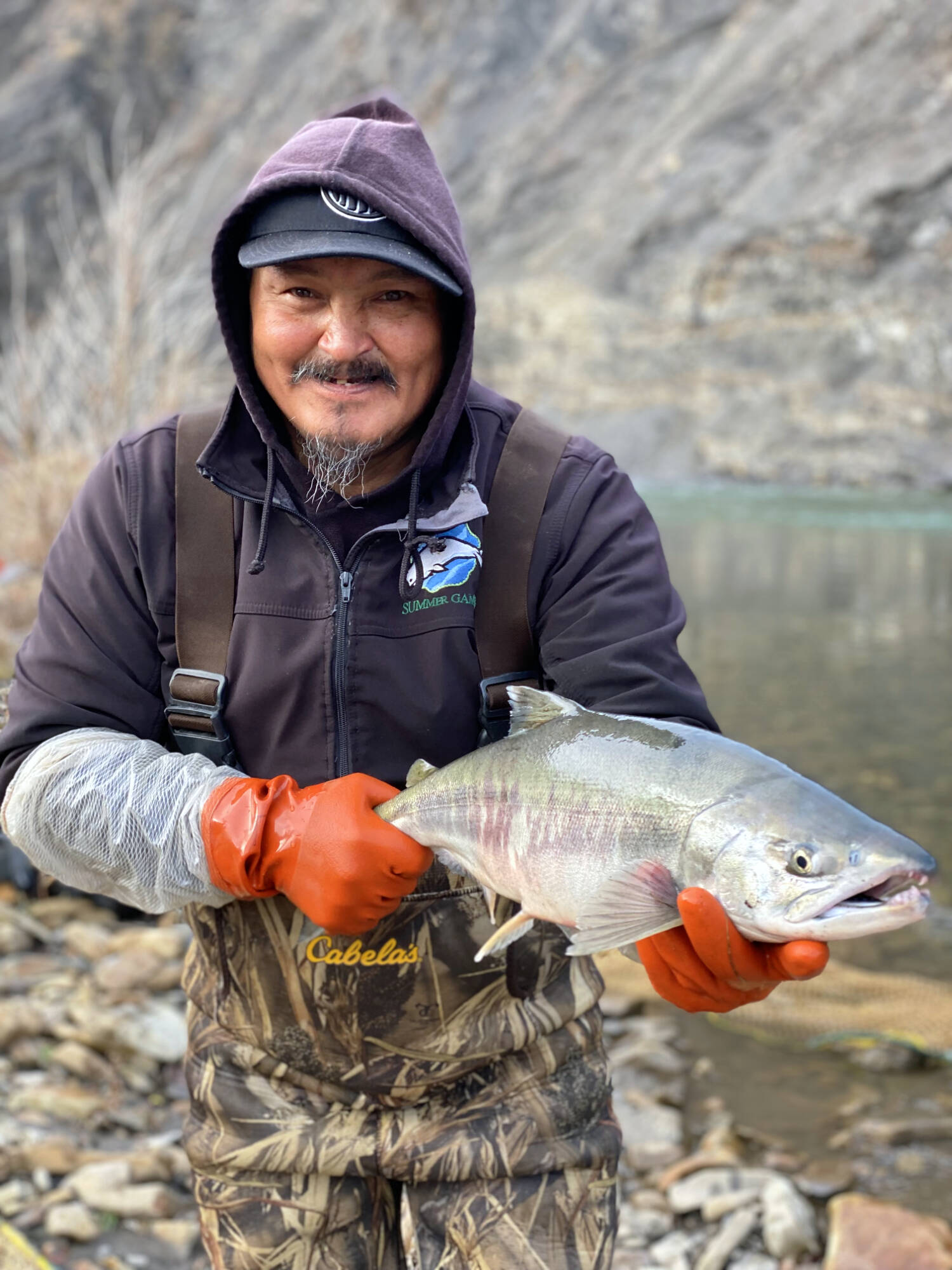Frank Dillon holding a chum salmon in 2023 at the Big Fish River in the Inuvialuit Settlement Region, which is located in both the Yukon and Northwest Territories. (Submitted/Colin Gallagher)